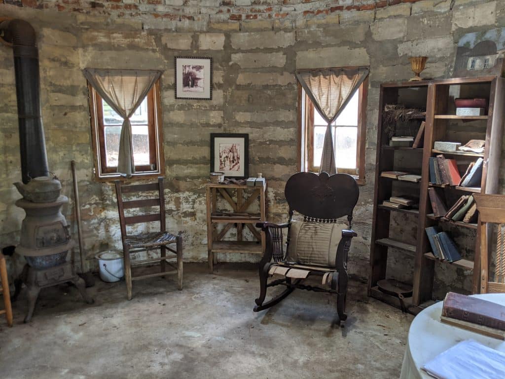 A small, rounded stone room filled with antiques