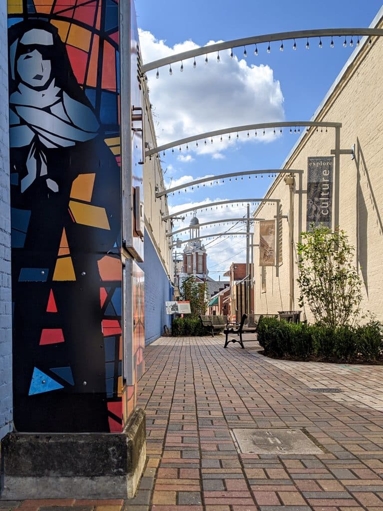 A mural of a nun decorates an alley that leads to an historic church on a weekend getaway in New Iberia.